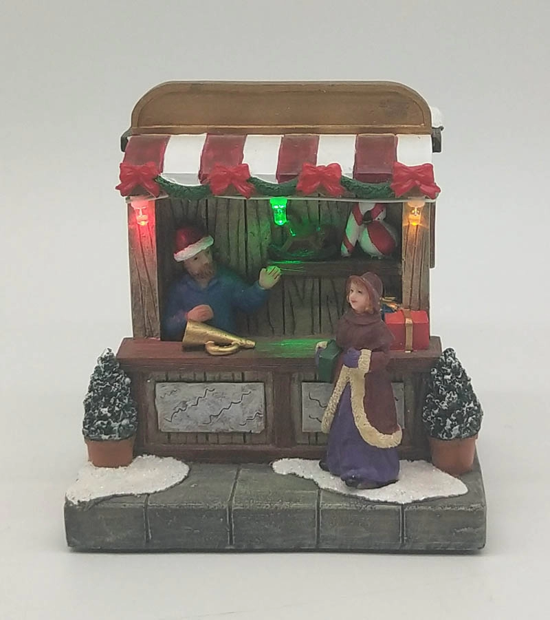 Tienda de juguetes de Navidad iluminada con mujer