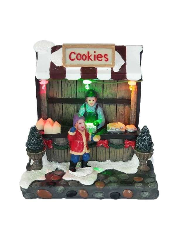 Tienda de galletas navideñas iluminadas con niño