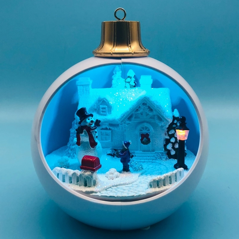 Pueblo navideño LED con muñeco de nieve moviéndose dentro de bola blanca